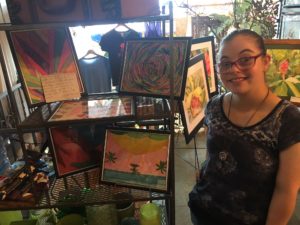 Allison displays her art work on the job at Stein's Florist