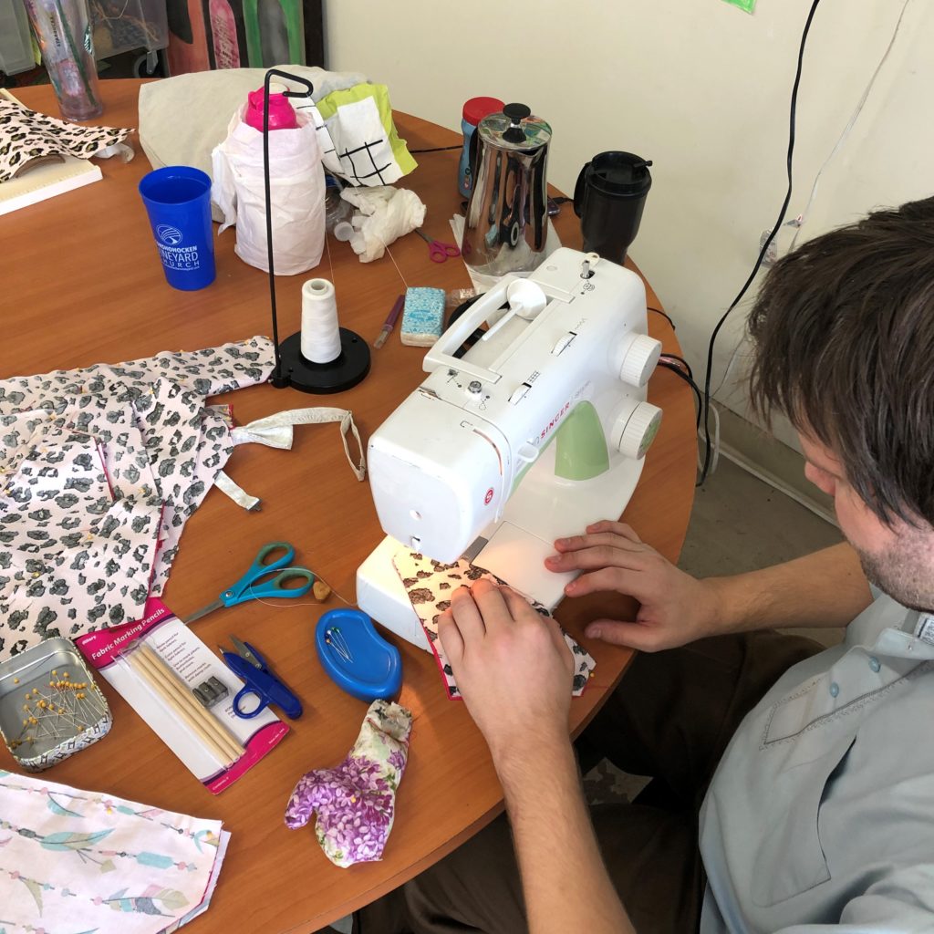 Picture of Jason working at sewing machine creating an item